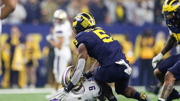 Michigan defensive end Josaiah Stewart tackles Washington quarterback Michael Penix Jr. during the first half of the national championship game at NRG Stadium in Houston, Texas on Monday, Jan. 8, 2024.