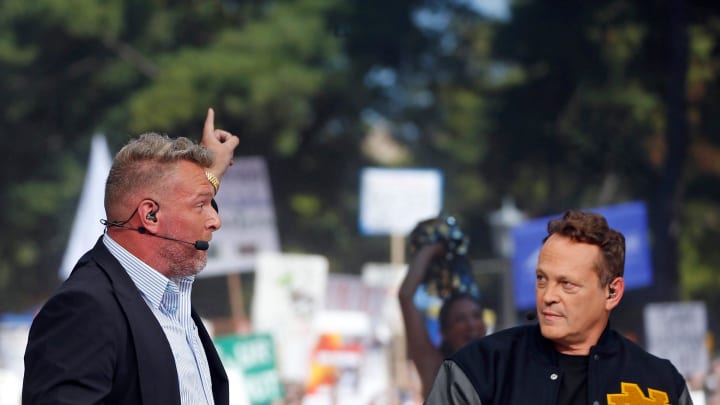 ESPN's Pat McAfee, left, points toward \"Touchdown Jesus\" while picking Notre Dame to beat Ohio State during \"College GameDay\" Saturday at Notre Dame.