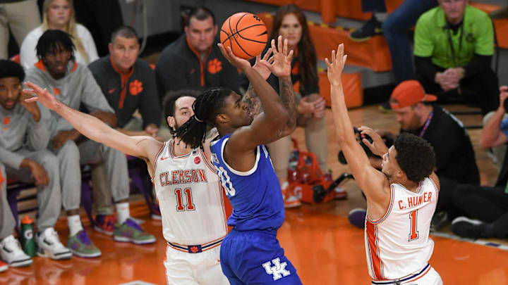 Dec 3, 2024; Clemson, South Carolina, USA; Kentucky guard Otega Oweh (00) makes a shot near Clemson guard Chase Hunter (1) during the first half at Littlejohn Coliseum. Mandatory Credit: Ken Ruinard-Imagn Images