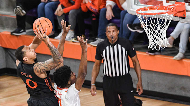 Feb 14, 2024; Clemson, South Carolina, USA;  Miami forward AJ Casey (0) scores near Clemson sophomore forward Chauncey Wiggins (21) during the first half at Littlejohn Coliseum Wednesday, February 14, 2024. Mandatory Credit: Ken Ruinard-Imagn Images