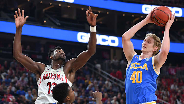 Mar 9, 2018; Las Vegas, NV, USA; UCLA Bruins center Thomas Welsh (40) pulls a rebound away from Arizona Wildcats forward Deandre Ayton (13) during a semi-final match of the Pac-12 Tournament at T-Mobile Arena. Mandatory Credit: Stephen R. Sylvanie-Imagn Images