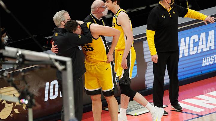 Iowa Hawkeyes center Luka Garza (55) hugs Iowa Hawkeyes head coach Fran McCaffery after their 95-80 loss against the Oregon Ducks during the second round of the 2021 NCAA Tournament on Monday, March 22, 2021, at Bankers Life Fieldhouse in Indianapolis, Ind. Mandatory Credit: Barbara Perenic/IndyStar via Imagn Images