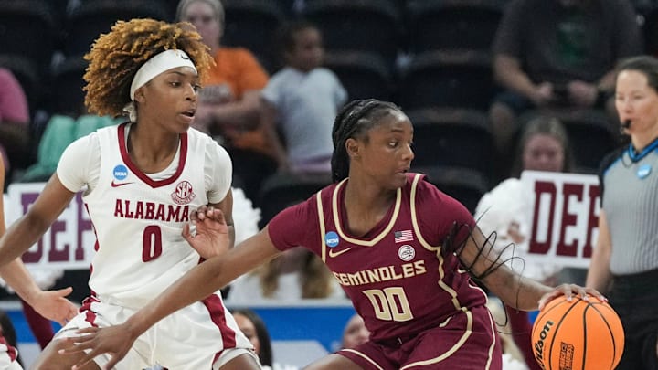 Florida State Seminoles guard Ta'Niya Latson (00) dribbles the ball while Alabama Crimson Tide guard Loyal McQueen (0) guards her as Alabama takes on Florida State in round one of the NCAA women's basketball tournament at the Moody Center in Austin Friday, March 22, 2024.
