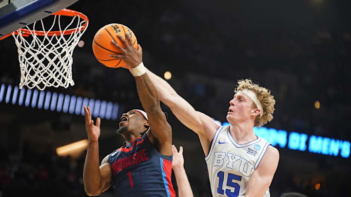 Richie Saunders contests a layup attempt by Duquesne