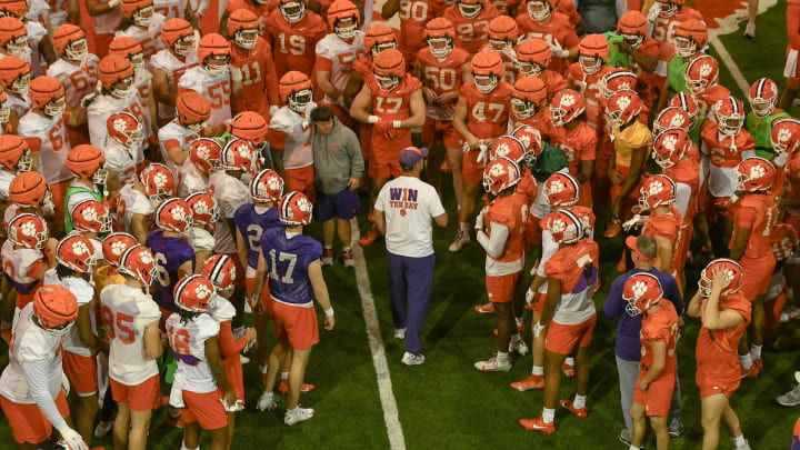 Clemson head coach Dabo Swinney in a player huddle during Spring practice