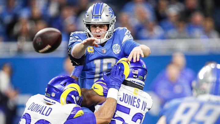 Detroit Lions quarterback Jared Goff makes a pass to tight end Brock Wright against Los Angeles Rams defensive tackle Aaron Donald and linebacker Ernest Jones during the first half of the NFC wild-card game at Ford Field in Detroit on Sunday, Jan. 14, 2024.