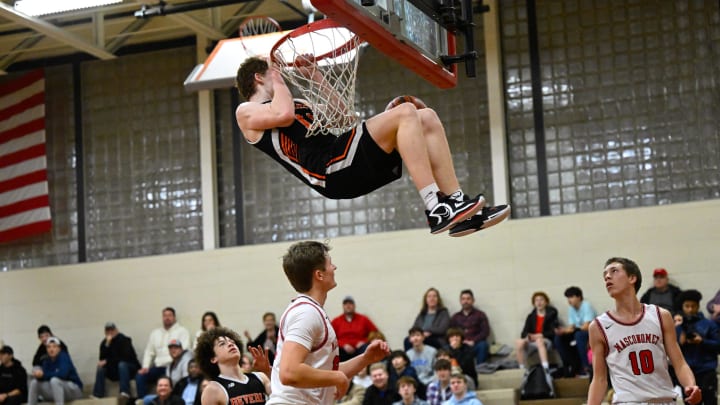 Ryder Frost of Beverly hangs onto the net after dunking the ball during a basketball game against Masconomet at Masconomet High School on Friday, Jan. 6, 2023. Beverly defeated Masconomet 77-53.

11003097002p Ma Bev Boysbasketball5ds