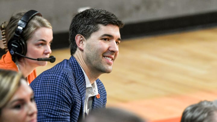 Graham Neff, Athletic Director, listens as Shawn Poppie, Clemson University Tigers women's basketball coach speaks during a press conference introducing him at Littlejohn Coliseum in Clemson, S.C. Monday, April 2, 2024.