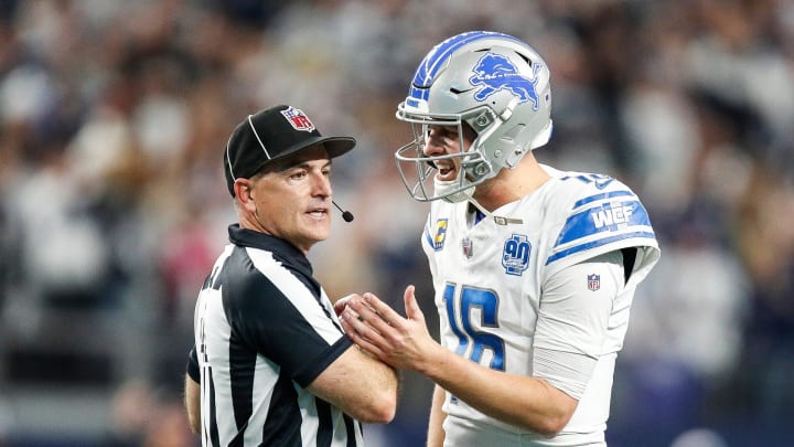 Lions quarterback Jared Goff talks to a referee.