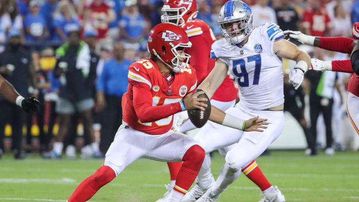 Detroit Lions defensive end Aidan Hutchinson (97) looks to tackle Kansas City Chiefs quarterback Patrick Mahomes (15).