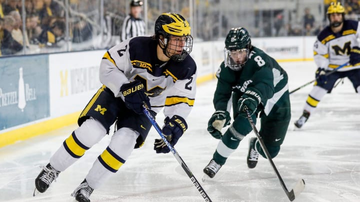 Michigan left wing Rutger McGroarty looks to pass against Michigan State defenseman Maxim Strbak during the third period at Yost Ice Arena in Ann Arbor on Friday, Feb. 9, 2024.