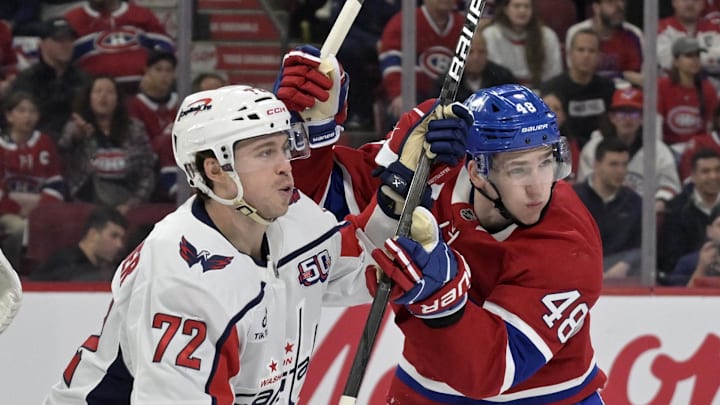 Apr 25, 2025; Montreal, Quebec, CAN; Washington Capitals forward Anthony Beauvillier (72) and Montreal Canadiens defenseman Lane Hutson (48) battle in front of the net during the first period in game three of the first round of the 2025 Stanley Cup Playoffs at the Bell Centre. Mandatory Credit: Eric Bolte-Imagn Images
