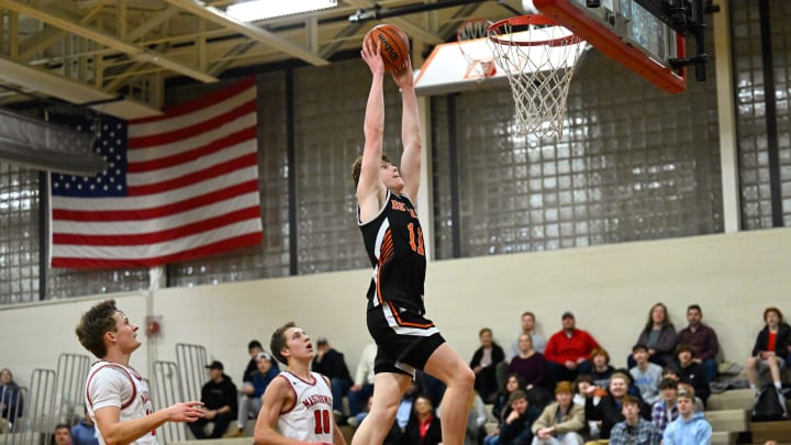 Ryder Frost of Beverly flies though the air as he dunks the ball during a basketball game against Masconomet at Masconomet High School on Friday, Jan. 6, 2023. Beverly defeated Masconomet 77-53.