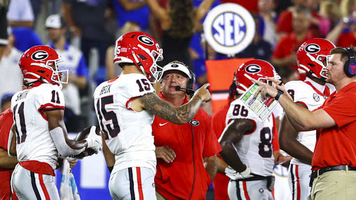 Sep 14, 2024; Lexington, Kentucky, USA; Georgia Bulldogs head coach Kirby Smart talks to quarterback Carson Beck (15) on the sidelines during the first quarter against the Kentucky Wildcats at Kroger Field. Mandatory Credit: Carter Skaggs-Imagn Images