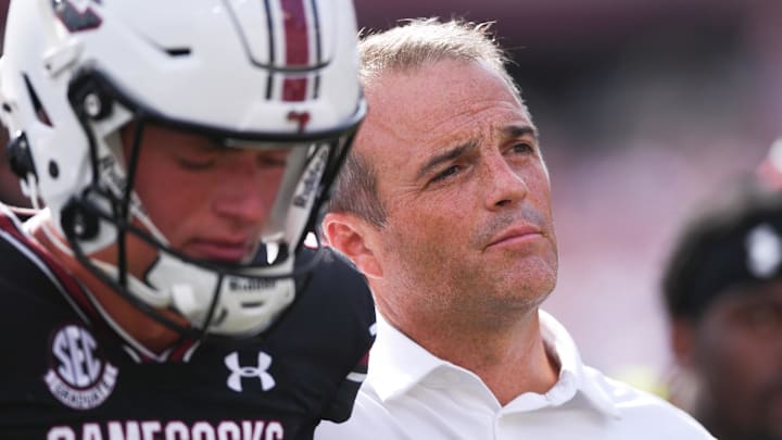 Sep 14, 2024; Columbia, South Carolina, USA; South Carolina Gamecocks head coach Shane Beamer listens to the alma mater with punter Kai Kroeger (39) after a game against the LSU Tigers at Williams-Brice Stadium.  Mandatory Credit: Ken Ruinard/USA TODAY Network via Imagn Images