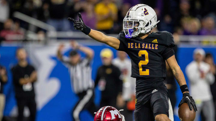 Warren De La Salle's Damion King IV points at the end zone after getting a first down against Muskegon's defense during the Division 2 football state championship game at Ford Field in Detroit on Saturday, Nov. 25, 2023.