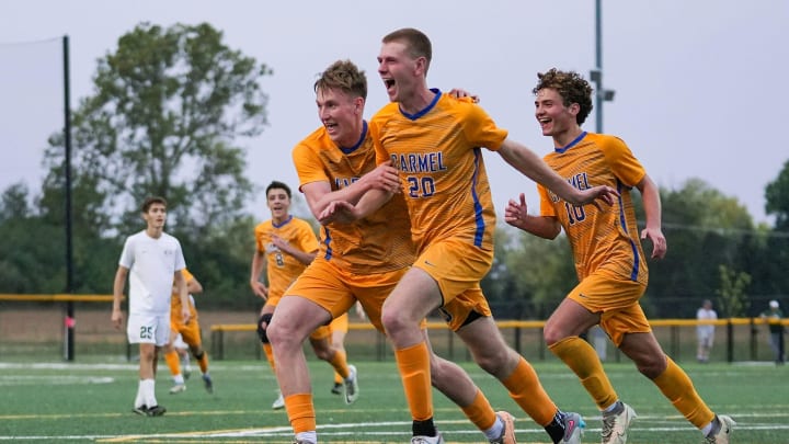 Carmel Greyhounds celebrate a goal by Ryan Barrett (20), center, on Wednesday, Oct. 4, 2023, during IHSAA boys soccer sectional 10 semifinals at Pearson Automotive Tennis Club in Zionsville, Ind. Carmel won, 3-1, advancing to finals.