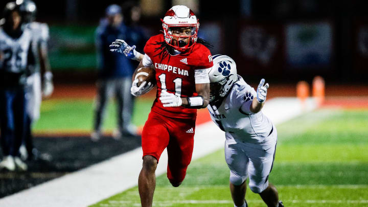 Clinton Township Chippewa Valley defensive back Dwight Downing runs after intercepting a pass intended for Macomb Dakota wide receiver Trent Morin during the second half of a MHSAA Division 1 district final at Chippewa Valley High School in Clinton Township on Friday, Nov. 3, 2023