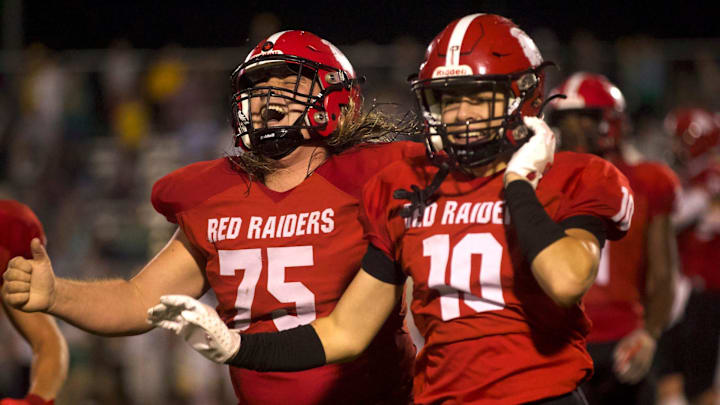 South Point football players run off the field with glee late in a game against Crest, the Red Raiders pulling off an improbable 27-26 win in Belmont.