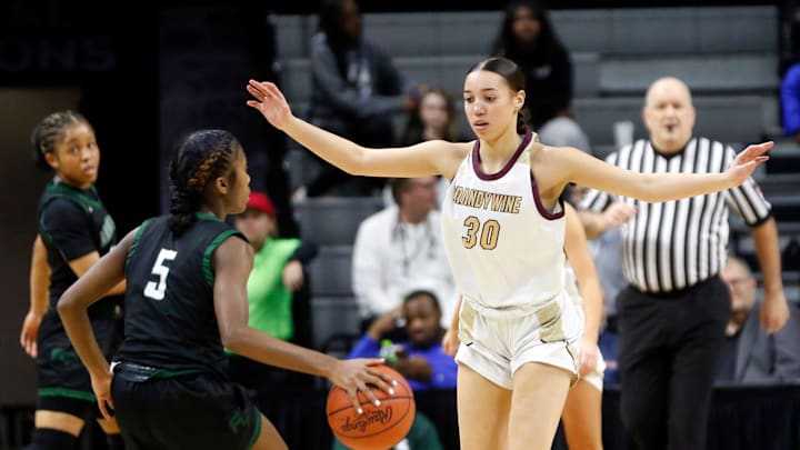 Brandywine junior Nyiah Mason (30) defends Arbor Prep senior Taylor Wallace during the MHSAA Division 3 girls basketball state championship game Saturday, March 23, 2024, at the Breslin Center in East Lansing, Mich.