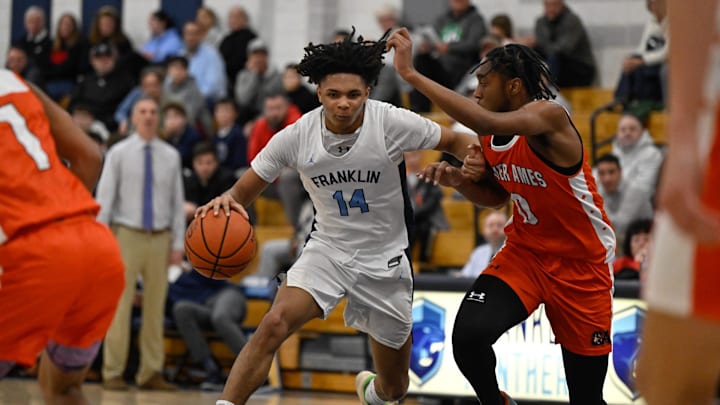 Franklin junior Justice Samuels moves the ball toward the basket while pressured by Oliver Ames junior Zaire Maddox during a basketball game at Franklin High School, Monday, Dec. 16, 2024. F Franklin junior Justice Samuels moves the ball toward the basket while pressured by Oliver Ames junior Zaire Maddox during a basketball game at Franklin High School, Monday, Dec. 16, 2024. F