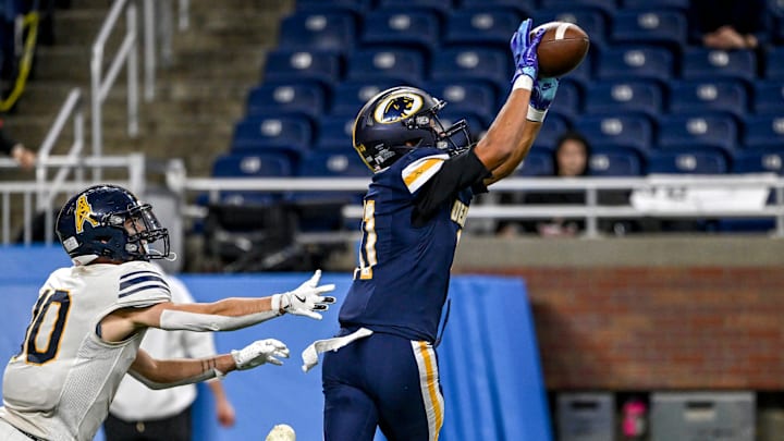 DeWitt's Jadon Bender, right, intercepts a pass intended for Mount Pleasant's Riley Olson during the third quarter in the Division 3 football state final on Sunday, Nov. 30, 2025, at Ford Field in Detroit.