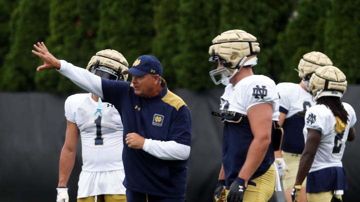 Notre Dame offensive coordinator Mike Denbrock gives instructions to senior tight end Kevin Bauman during a practice Friday, August 2, 2024, at the Irish Athletics Center in South Bend.