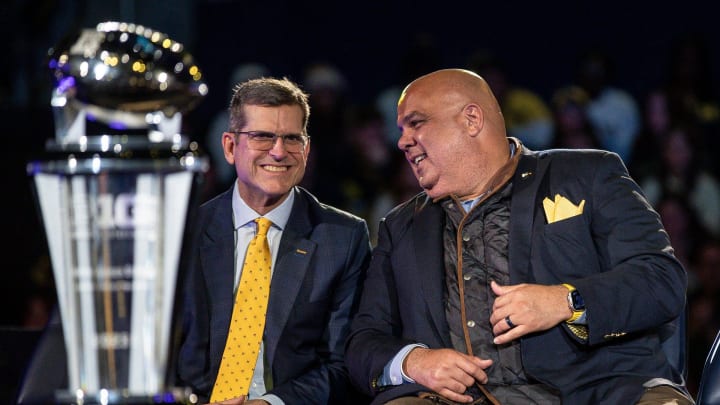 Jan 13, 2024; Ann Arbor, MI, USA; Michigan head coach Jim Harbaugh talks to athletic director Warde Manuel during the national championship celebration at Crisler Center in Ann Arbor on Saturday, Jan. 13, 2024. Mandatory Credit: Junfu Han-USA TODAY Sports