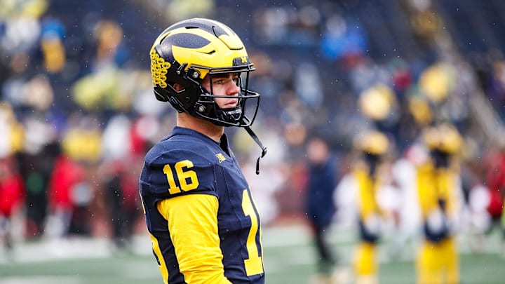 Michigan quarterback Davis Warren (16) warms up before the Indiana game at Michigan Stadium in Ann Arbor on Saturday, Oct. 14, 2023.