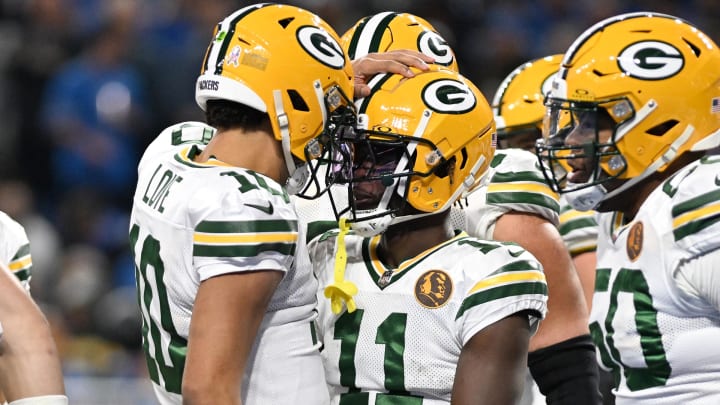 Green Bay Packers wide receiver Jayden Reed (11) celebrates with quarterback Jordan Love (10) after scoring a touchdown against the Detroit Lions at Ford Field. 