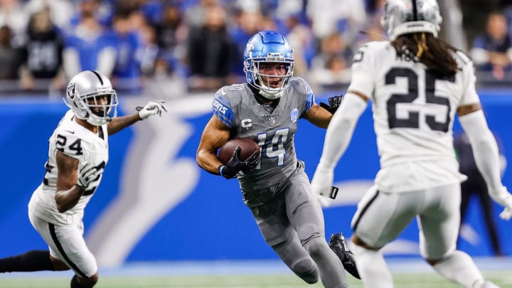 Lions wide receiver Amon-Ra St. Brown runs against Raiders safety Tre'von Moehrig during the first half at Ford Field on Monday, Oct. 30, 2023.