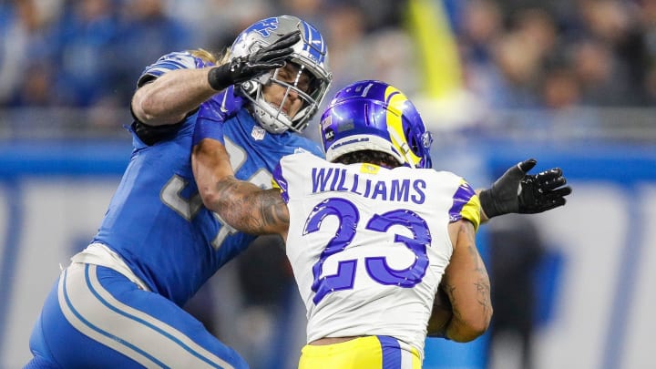 Detroit Lions linebacker Alex Anzalone tackles L.A. Rams running back Kyren Williams during the first half of the NFC wild-card game at Ford Field in Detroit on Sunday, Jan, 14, 2024.