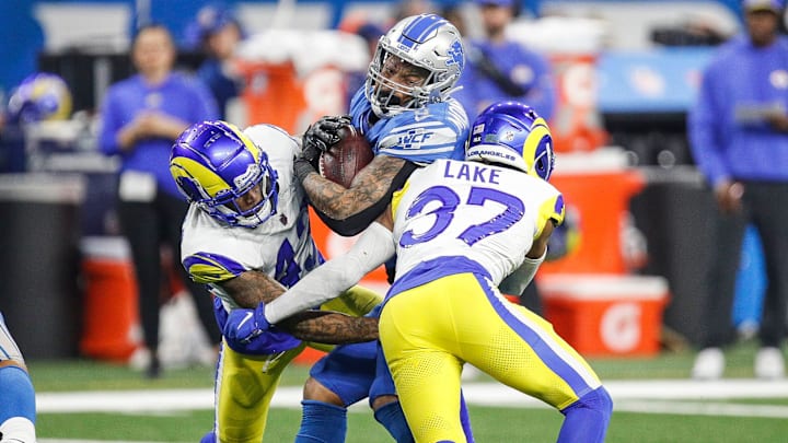 Detroit Lions running back David Montgomery runs against Los Angeles Rams safety Quentin Lake during the first half of the NFC wild-card game at Ford Field in Detroit on Sunday, Jan. 14, 2024.