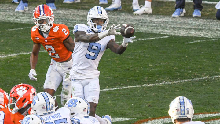 North Carolina Tar Heels wide receiver Devontez Walker (9) catches a ball near Clemson Tigers cornerback Nate Wiggins (2) during the first quarter at Memorial Stadium. 