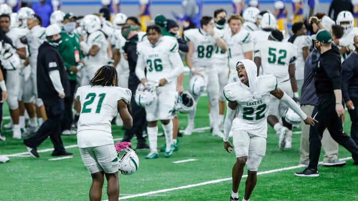 West Bloomfield defensive back BJ Rankin (21) and Maxwell Hairston (22) celebrate the 41-0 win over Davison during the MHSAA Division 1 final at Ford Field, Saturday, Jan. 23, 2021.