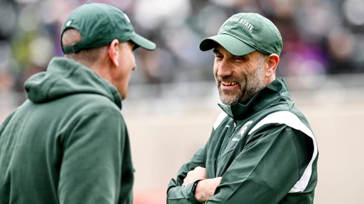 Michigan State defensive coordinator Joe Rossi, right, talks with offensive coordinator Brian Lindgren during the Spring Showcase on Saturday, April 20, 2024, at Spartan Stadium in East Lansing.