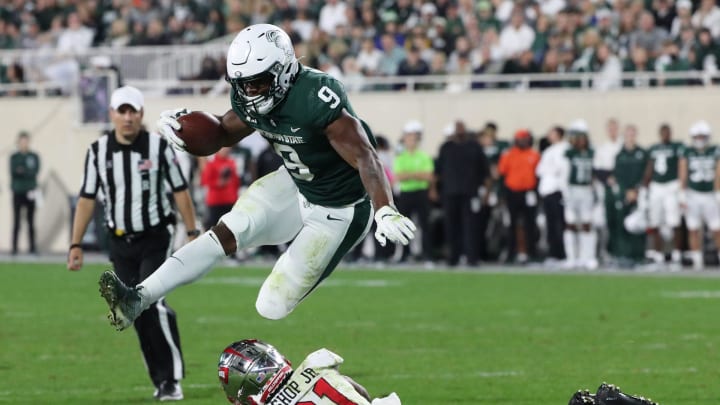 Michigan State Spartans running back Kenneth Walker III jumps over Western Kentucky Hilltoppers defensive back Beanie Bishop on Saturday, Oct. 2, 2021.

Msu Wku