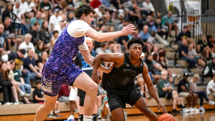 Michigan State and Team Motorcars' Jeremy Fears, right, moves the ball as Team Case Credit Union's Ugnius Jarusevicius defends in the game on Thursday, July 18, 2024, during the Moneyball Pro-Am at Holt High School.