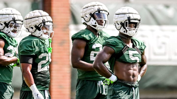 From left, Michigan State running backs Makhi Frazier, Joseph Martinez, Shawn Foster and Nathan Carter look on during a break in the action on the first day of football camp on Tuesday, July 30, 2024, in East Lansing.