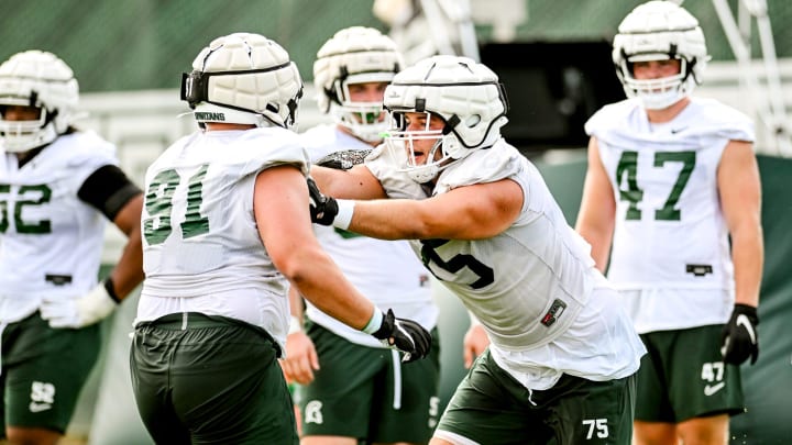 Michigan State's Ben Nelson, right, and Michael Masunas work in a drill during the first day of football camp on Tuesday, July 30, 2024, in East Lansing.