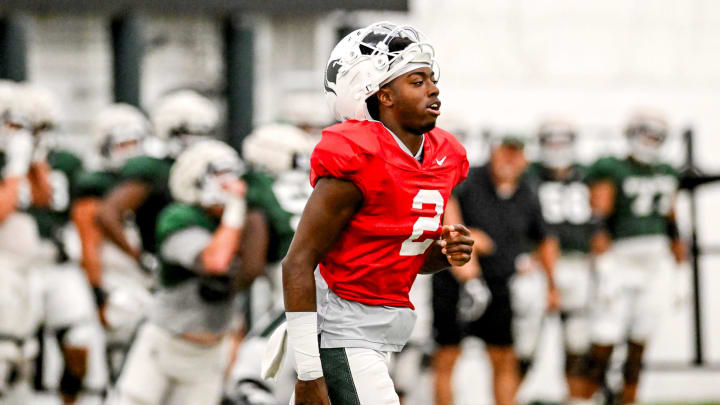 Michigan State's Aidan Chiles heads over with the quarterbacks for a drill during camp on Monday, Aug. 5, 2024, at the indoor practice facility in East Lansing.