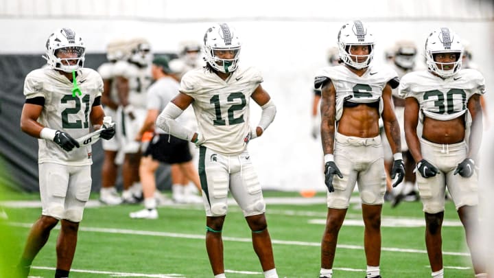 From left, Michigan State defensive backs Dillon Tatum, Justin Denson Jr., Ade Willie and Aveon Grose look on during camp on Monday, Aug. 5, 2024, at the indoor practice facility in East Lansing.