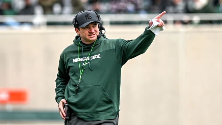 Michigan State's head coach Jonathan Smith communicates with staff on Saturday, April 20, 2024, at Spartan Stadium in East Lansing.