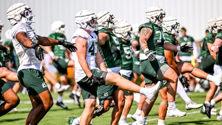 Michigan State players warm up during the first day of football camp on Tuesday, July 30, 2024, in East Lansing.