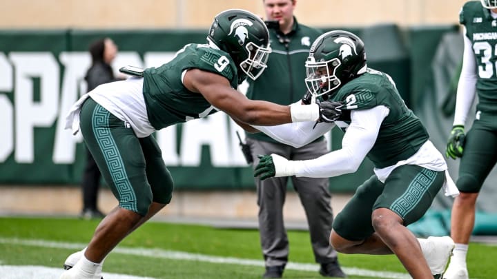 Michigan State's Jalen Thompson, left, and Khris Bogle work out in a drill during the Spring Showcase on Saturday, April 20, 2024, at Spartan Stadium in East Lansing.