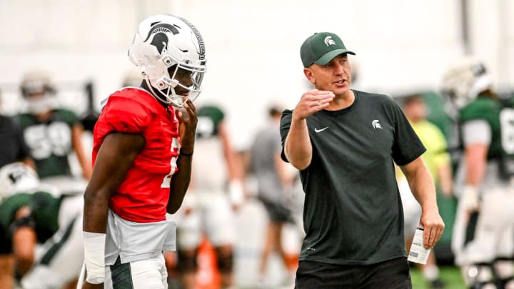 Michigan State's offensive coordinator Brian Lindgren, right, talks with quarterback Aidan Chiles during camp on Monday, Aug. 5, 2024, at the indoor practice facility in East Lansing.