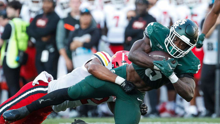 Michigan State running back Nathan Carter runs against Maryland defensive back Dante Trader Jr. during the second half of MSU's 31-9 loss on Saturday, Sept. 23, 2023, in East Lansing.