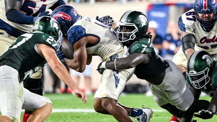 Michigan State's Jordan Turner, right, tackles Florida Atlantic's CJ Campbell, Jr. during the fourth quarter on Friday, Aug. 30, 2024, at Spartan Stadium in East Lansing.