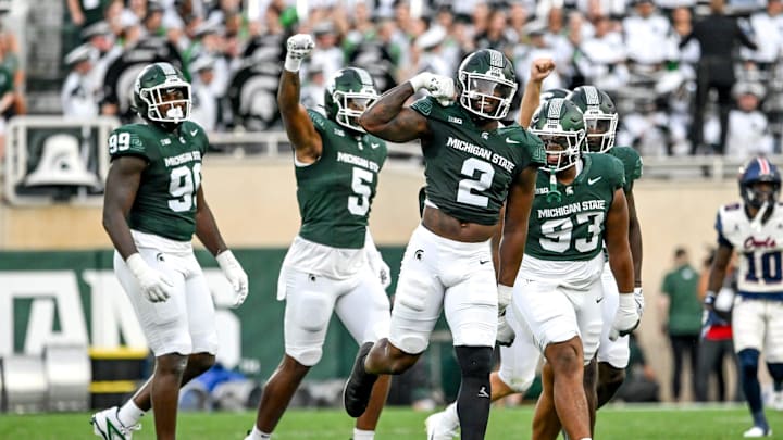 Michigan State's Khris Bogle, center, celebrates his stop against Florida Atlantic during the first quarter on Friday, Aug. 30, 2024, at Spartan Stadium in East Lansing.