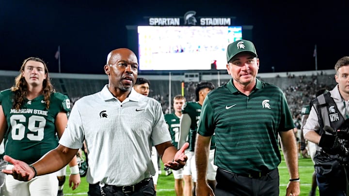 Michigan State football coach Jonathan Smith, right, talks with athletic director Alan Haller after MSU's victory over Florida Atlantic on Friday, Aug. 30, 2024, at Spartan Stadium in East Lansing.